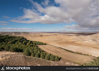 Countryside landscape in Burgos province, Castilla y Leon, Spain. Blue sky and clouds sky over the agricultural fields.
