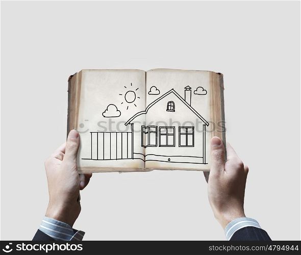 Countryside life. Close up of male hands holding opened book