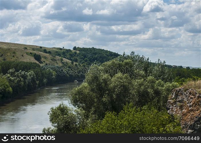 Countryside natural panoramic landscape with river and hills on clear summer sunny day