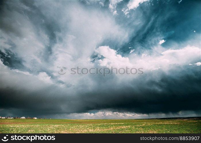 Countryside Rural Field Spring Meadow During Rain. Rain Clouds On Horizon. Agricultural And Weather Forecast Concept.