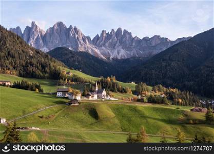 Countryside sunny autumn view of the St. Magdalena, Santa Maddalena in the National Park Puez Odle or Geisler summits. Dolomites, South Tyrol. Italy, Europe.. Countryside sunny autumn view of the St. Magdalena, Santa Maddalena in the National Park Puez Odle