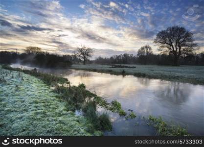 Countryside sunrise landscape with dramatic sky and flowing river