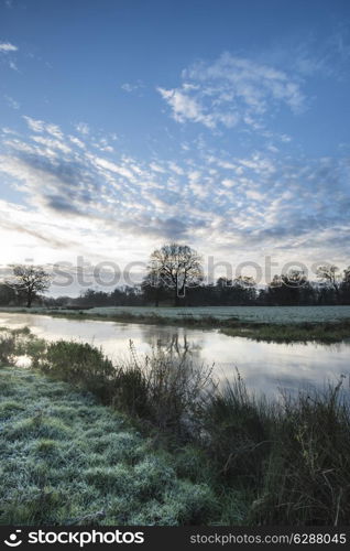 Countryside sunrise landscape with dramatic sky and flowing river