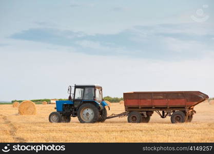countryside transportation, tractor at the field. tractor at the field
