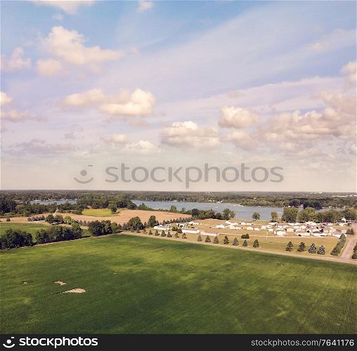 Countryside with residential buildings and lake view. Aerial landscape.