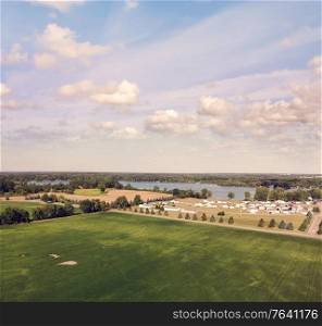 Countryside with residential buildings and lake view. Aerial landscape.