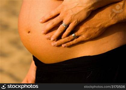 Couple&acute;s Hands on Pregnant Belly