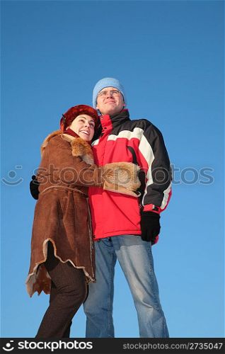 couple against blue sky background in winter