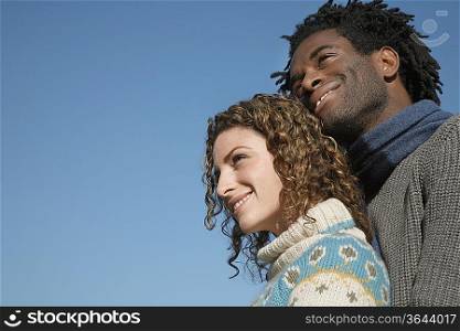Couple against sky, low angle view