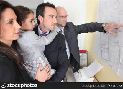 couple and child in architect&rsquo;s office