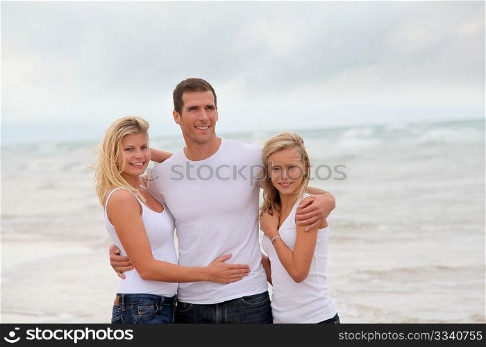Couple and daughter standing by the sea