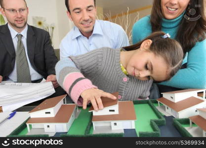 Couple and realtor watching model