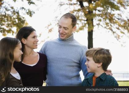 Couple and their two children standing together and smiling