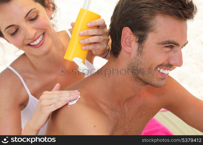 Couple applying suncream