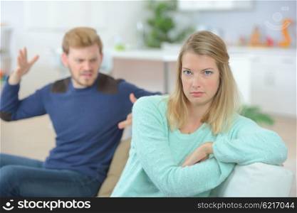 Couple arguing on the sofa
