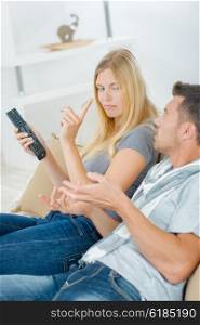 Couple arguing over remote control