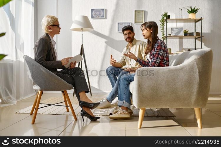 Couple arguing with each other on therapy session. Discussion relationship with marriage counselor. Couple arguing each other on therapy session