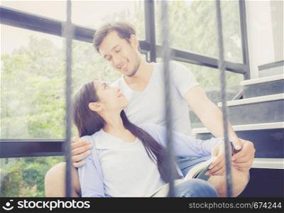 Couple asian handsome man and beautiful woman reading book and smile at home, boyfriend and girlfriend with activities together for leisure, education concept.