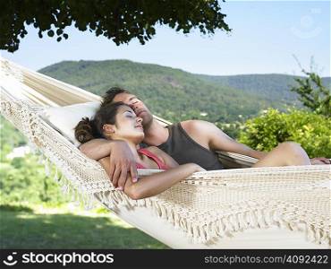 Couple asleep on hammock