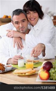 Couple at breakfast in bathrobes