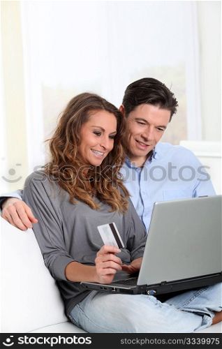 Couple at home doing online shopping