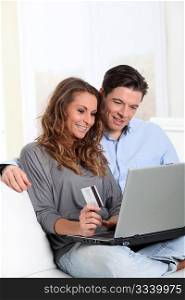 Couple at home doing online shopping