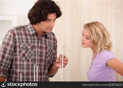 Couple at home looking at wire