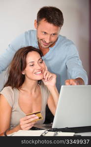 Couple at home shopping on internet