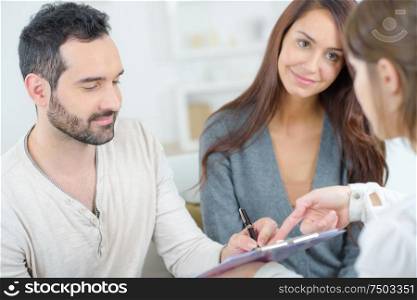 couple at home signing paper