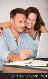 Couple at home surfing on internet