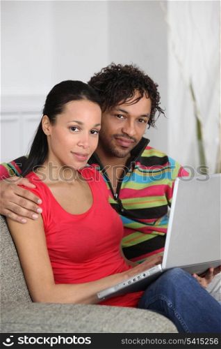 Couple at home using a laptop computer