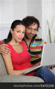 Couple at home using a laptop computer
