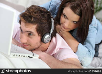 Couple at home watching laptop computer