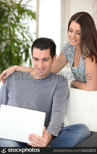 Couple at home watching laptop screen