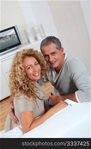 Couple at home watching television