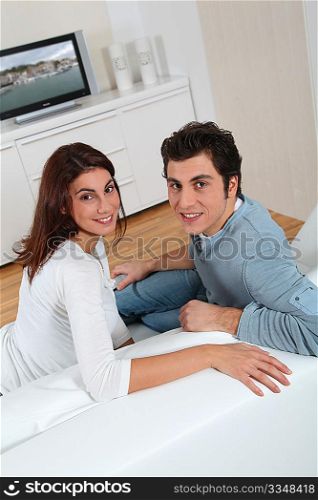 Couple at home watching television