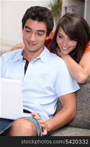 Couple at home with laptop