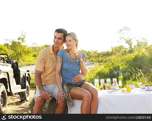 Couple at picnic sitting and embracing
