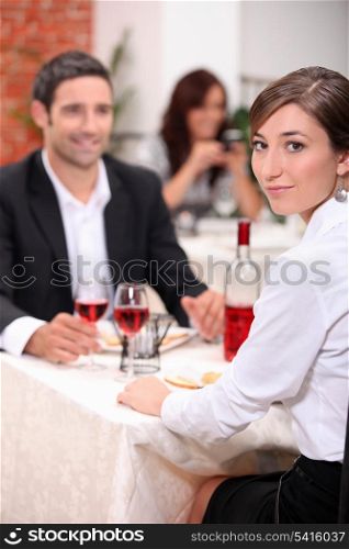 couple at restaurant with woman turned to camera