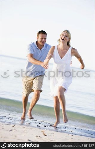 Couple at the beach playing and smiling