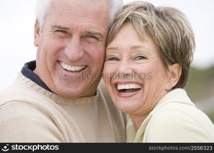 Couple at the beach smiling