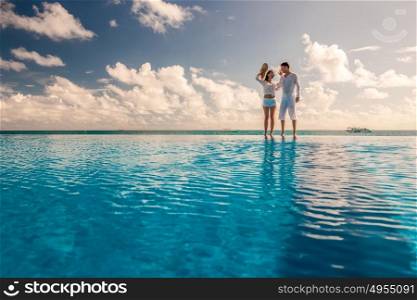 Couple at the poolside against sky