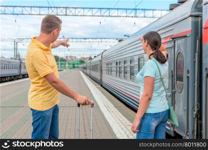 couple at the railway station waiting for the train