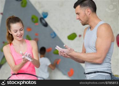 couple at the rock climbing wall at the gym