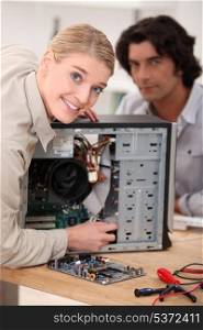 Couple attempting to repair computer
