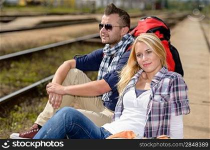 Couple backpack traveling resting on railroad trip tourists vacation togetherness