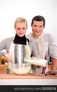 Couple baking together in kitchen