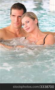 Couple bathing in jacuzzi of spa center