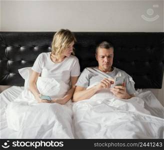 couple bed using mobiles 3