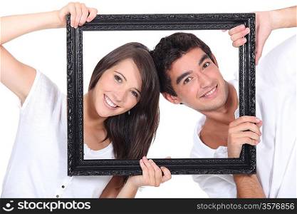 couple behind black frame